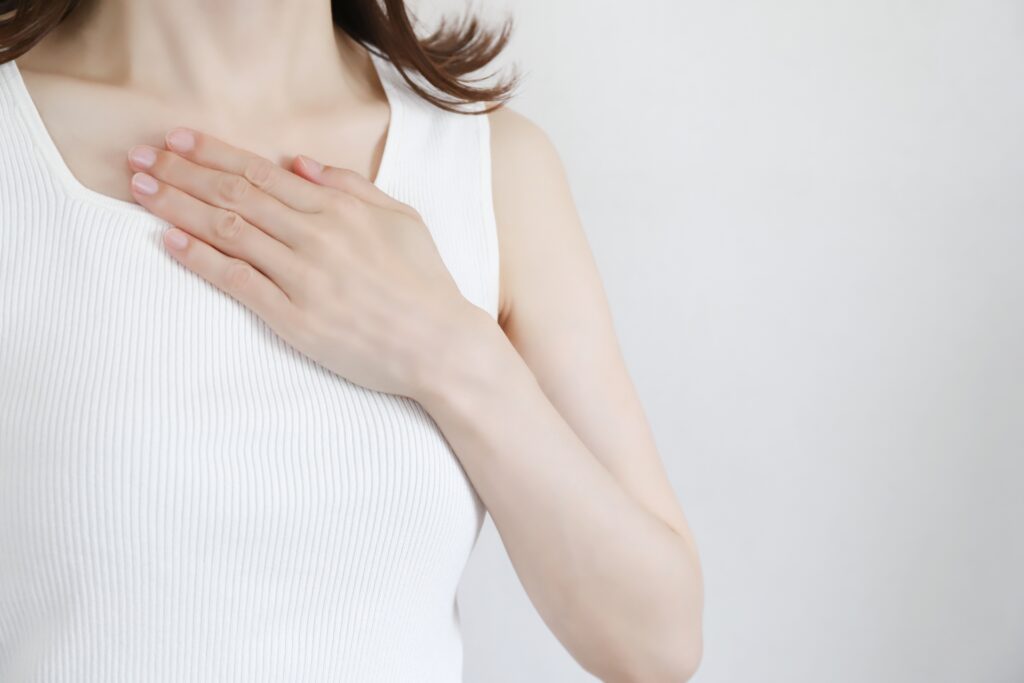 胸に手を当てる女性